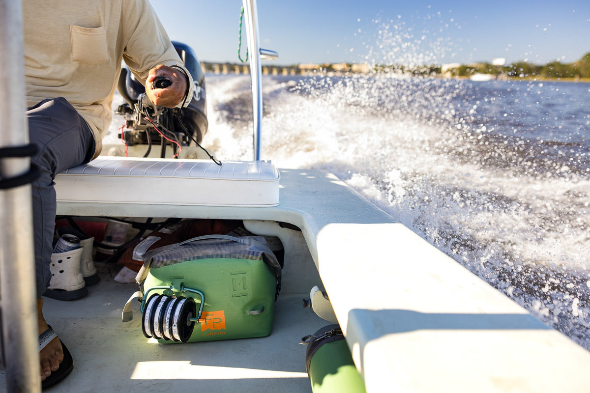 Fishpond Thunderhead HD Roll-Top Boat Bag - Yucca, on the deck of a moving boat