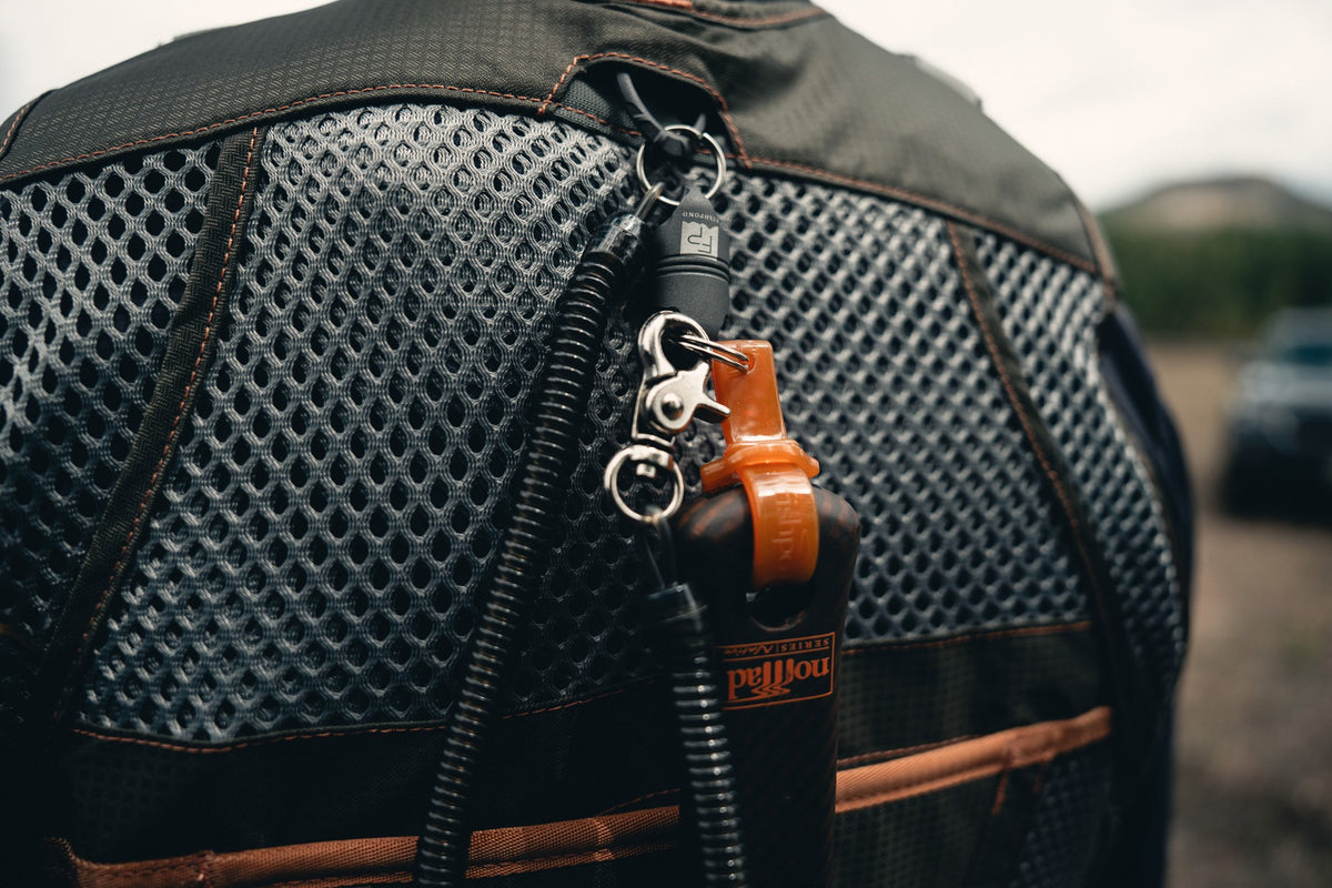 Fishpond Confluence Net Release 2.0 - Tungsten, close-up clipped to a fishing vest