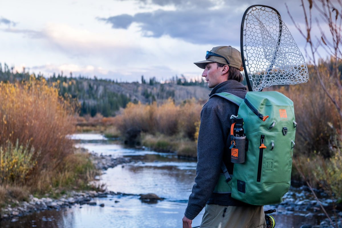Fishpond Thunderhead Bear Spray Holder - Smoke Grey, attached to a backpack shoulder strap