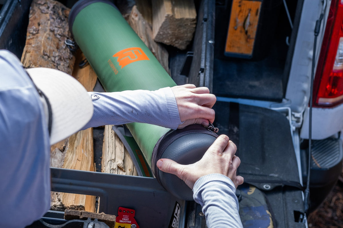 Fishpond Short Haul Rod Case - Yucca, being opened in a truck bed