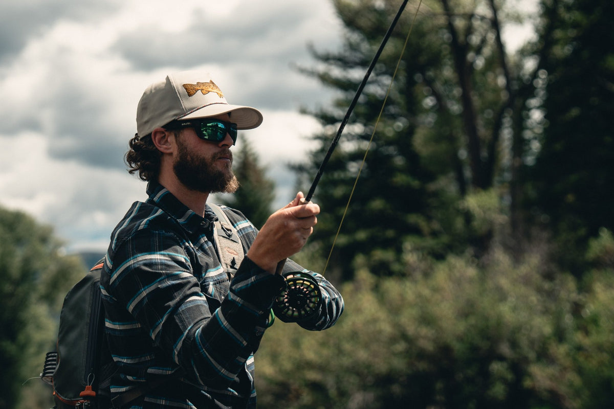 Fishpond Hometown Hat - Sand, worn by angler casting