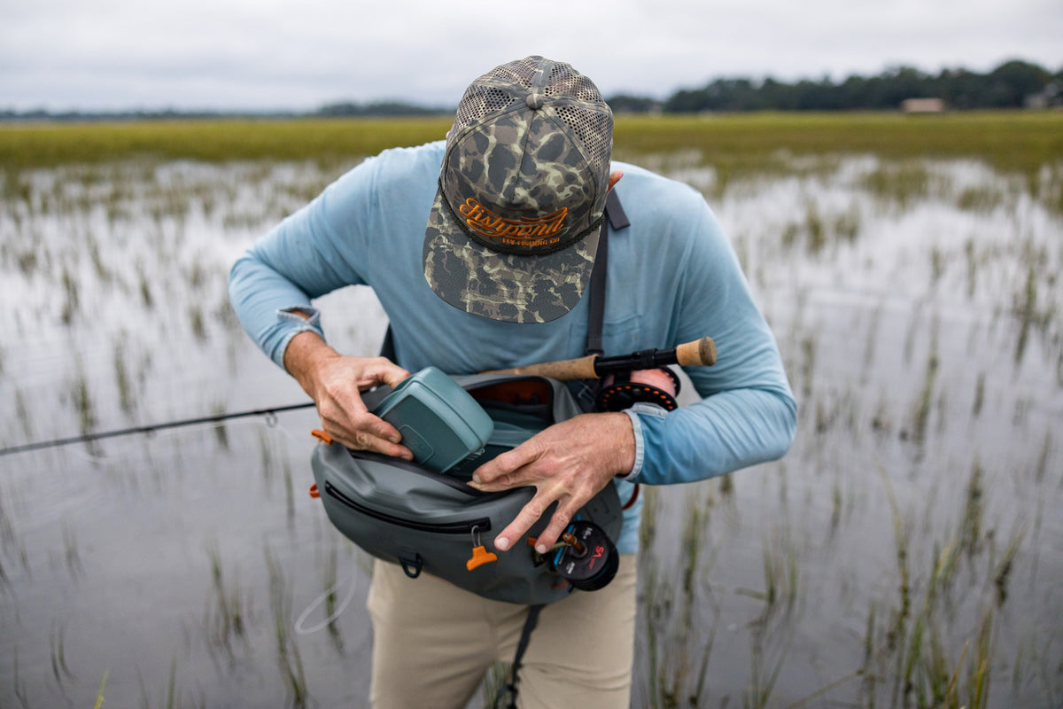Fishpond Thunderhead HD Sling, Overcast Grey, angler opening the sling