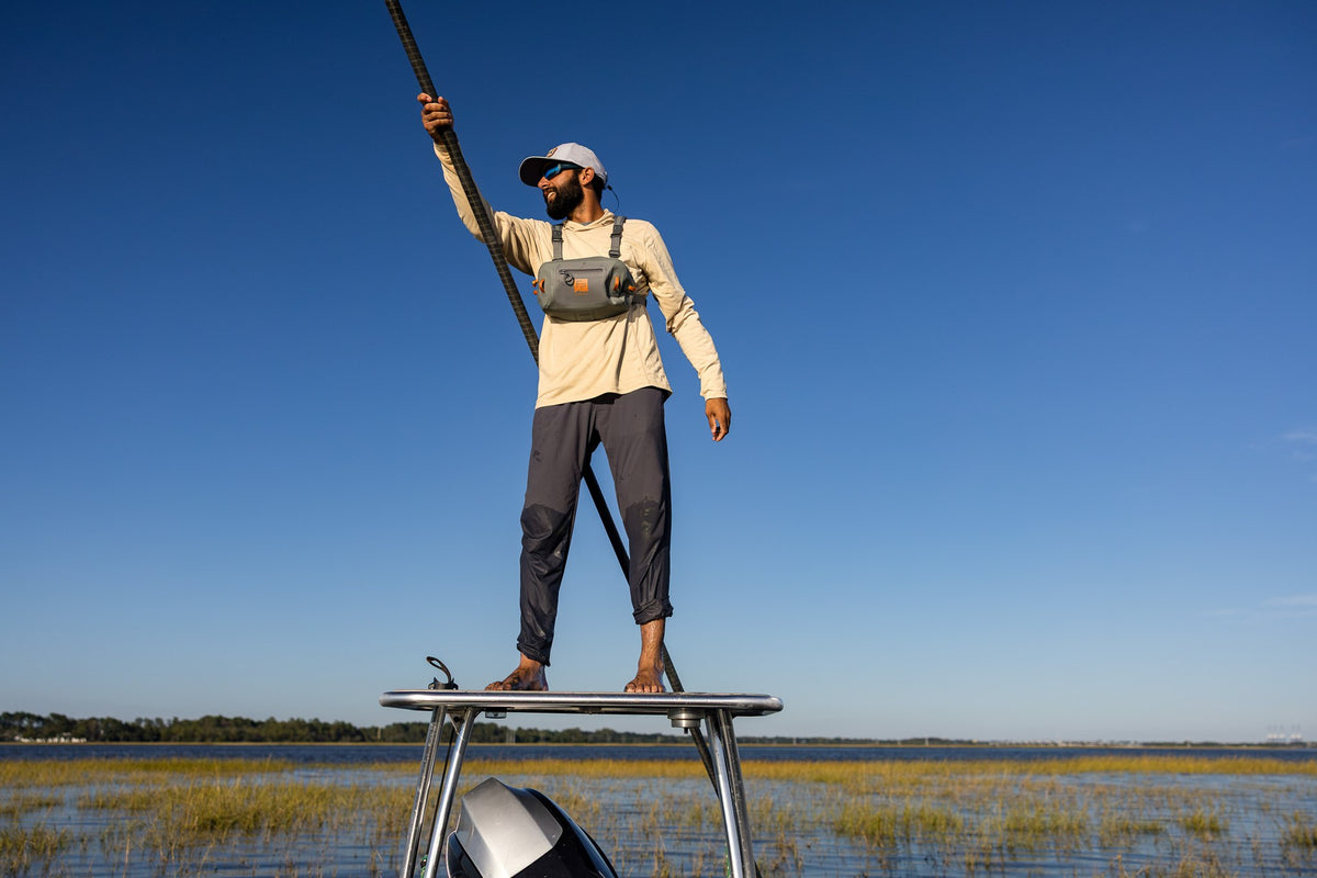 Fishpond Thunderhead HD Chest Pack - Overcast Grey, worn by angler poling a skiff