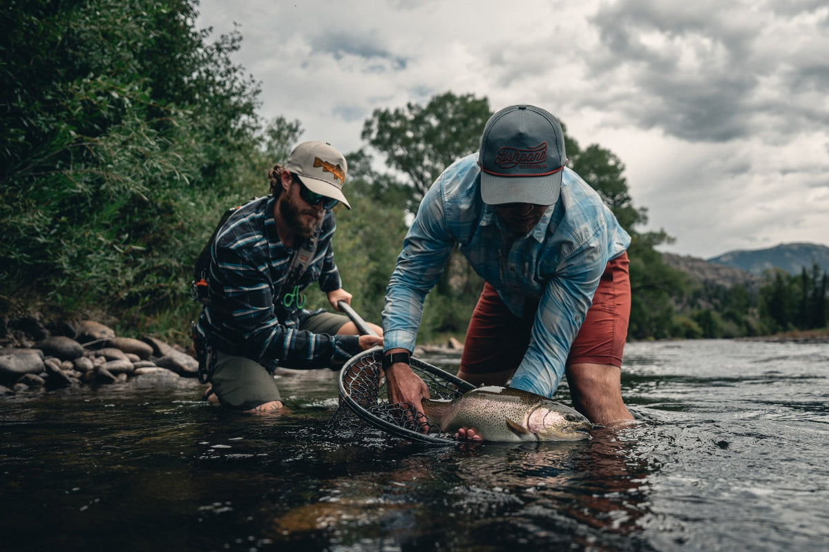 Fishpond Nomad Boat Net - Shadowcast Camo - 2.0, two anglers releasing a trout