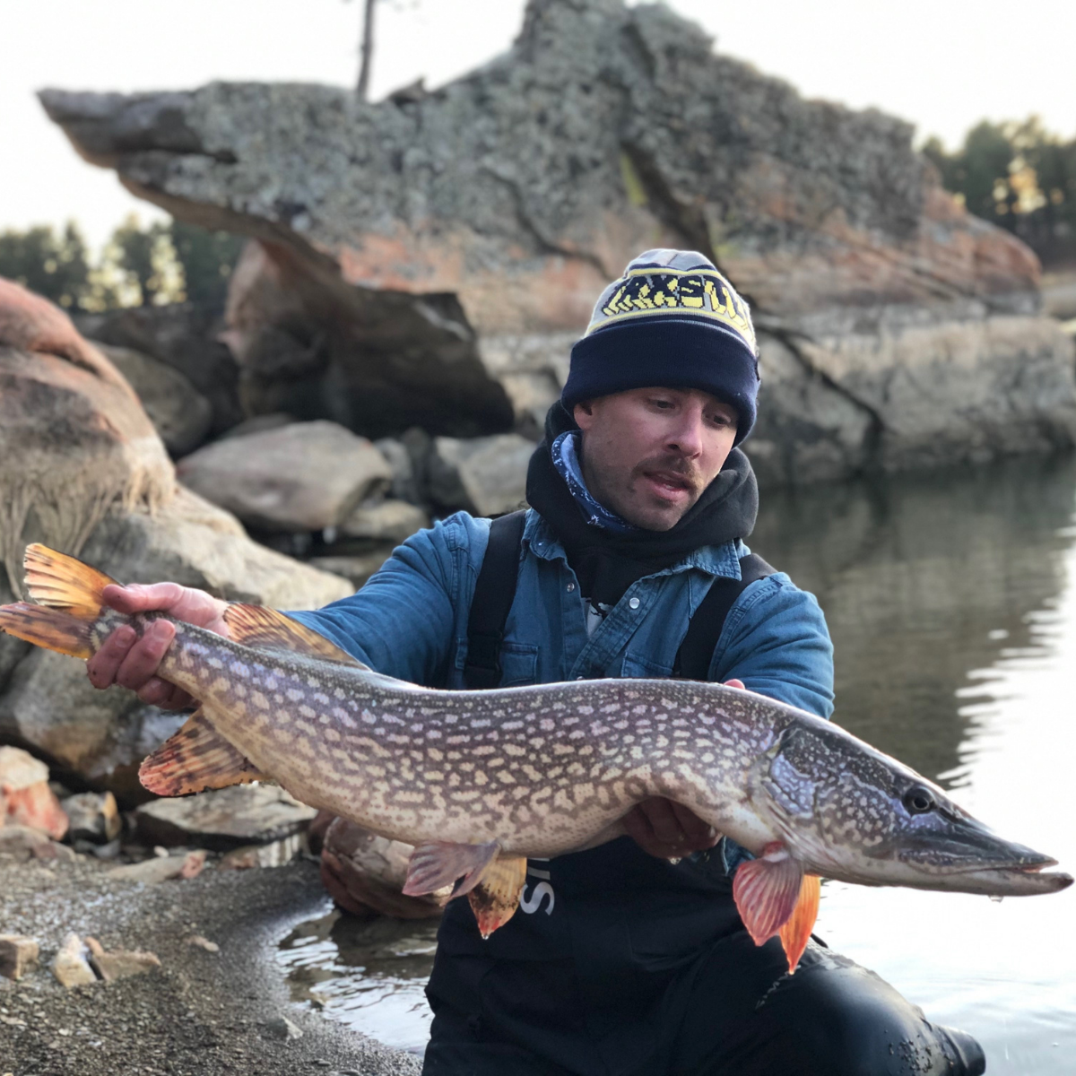 Trxstle Arcade Beanie With a Guy holding a Northern Pike