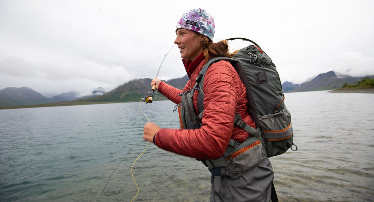 Fishpond Firehole Backpack worn by a woman fly angler