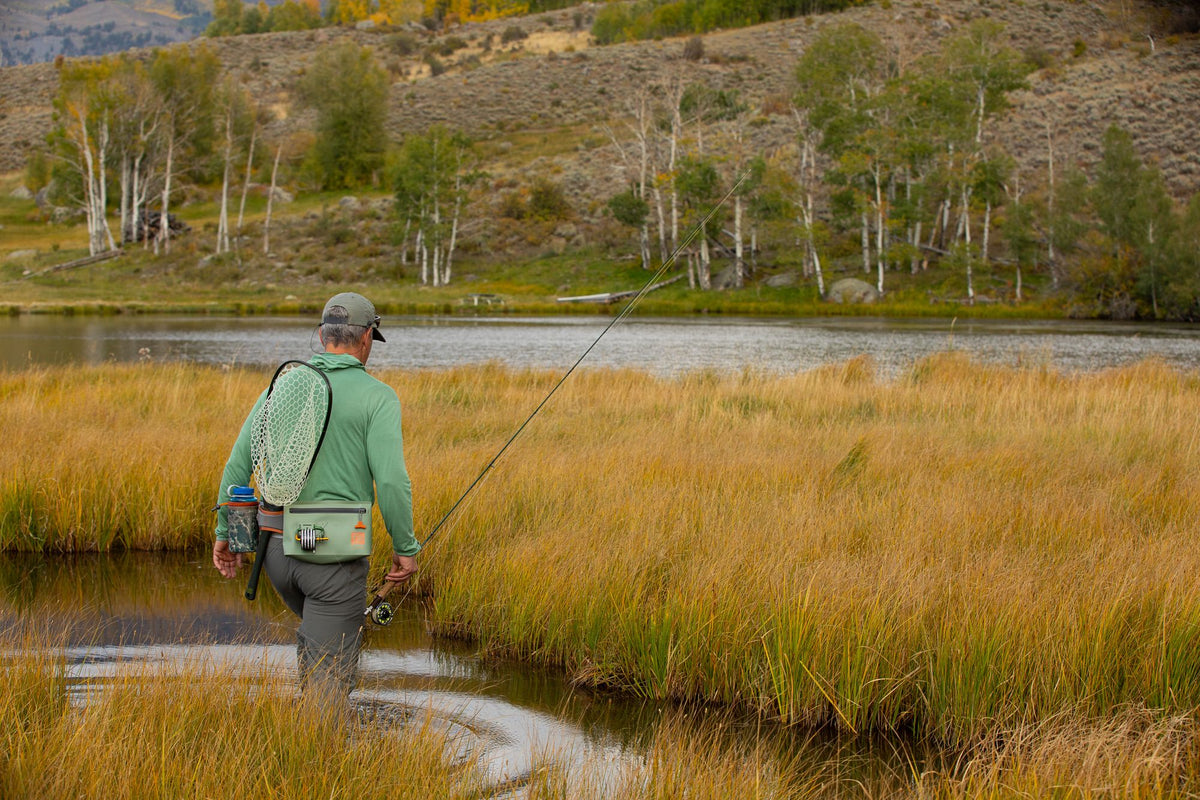 Guy Walking to The River Wearing Fishpond South Fork Wader Belt